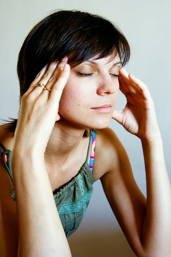 A woman massaging her temples