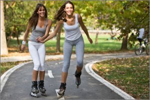 Two women rollerblading 