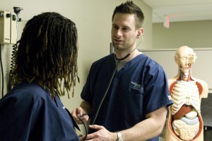 Medical students listening to each others' heartbeat