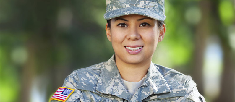 Close up of a military veteran, she is smiling and wearing her fatigues.