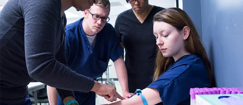 Students learning how to properly draw blood.