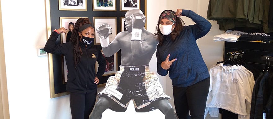 WellSpring students posing in front of a Floyd Mayweather cardboard cut-out.